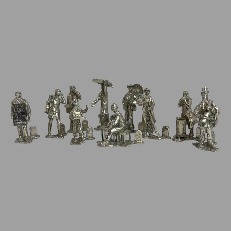 Main photo of novelty silver name/menu holders with 8 of the taller figures in a row at the back and the young match seller and seated cane chair restorer are in the centre foreground. It's great fun to go back in time to discover what street sellers actually sold as these tradesmen are now long gone. Each piece has been created with incredible attention to detail which we'll go into as we go on. Fantastic gift item.