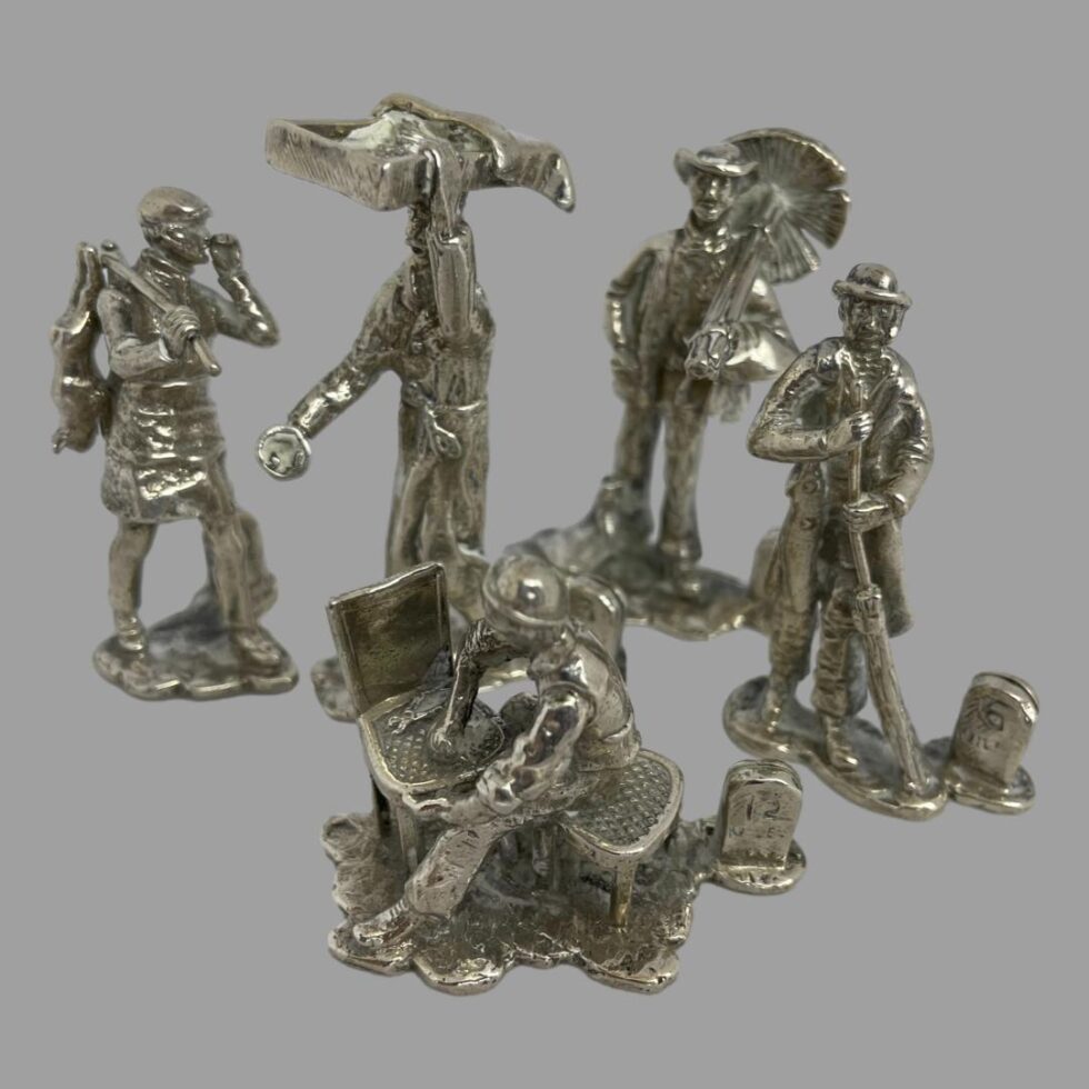 Photo of the 5 including rabbit seller seen from a slightly raised angle looking down to show off their wares more.