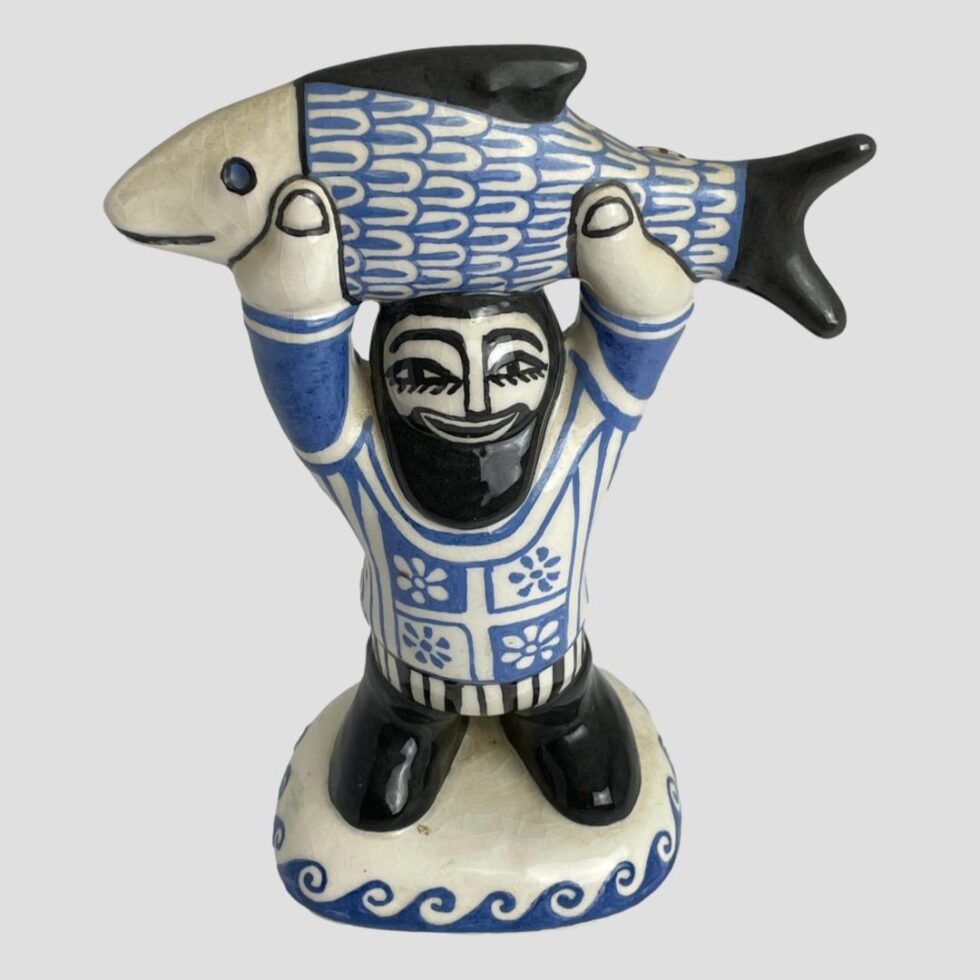 Photo of fisherman this time seen from a slightly raised angle looking diagonally down. Incredibly the fishermans eyes appear to move with the direction so here he looks as if his eyes are looking up at you.