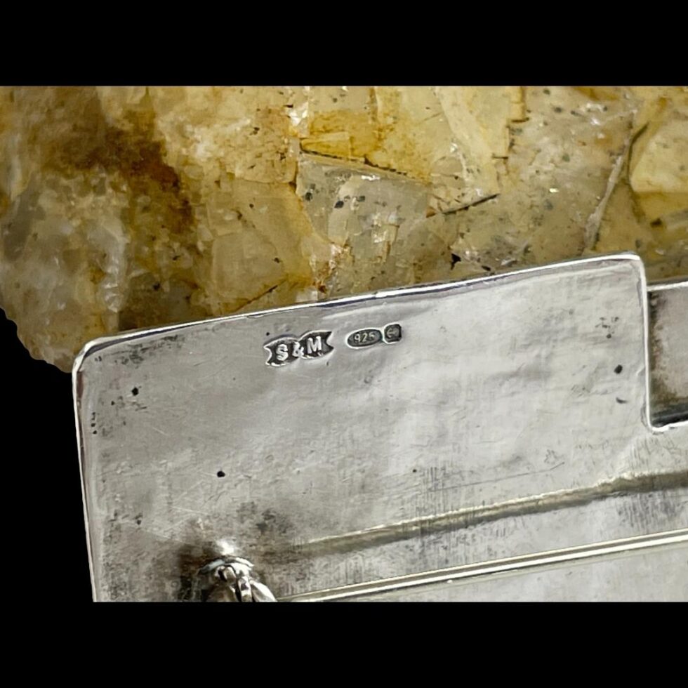 Close up photo of the hallmark on Modernist style silver brooch.