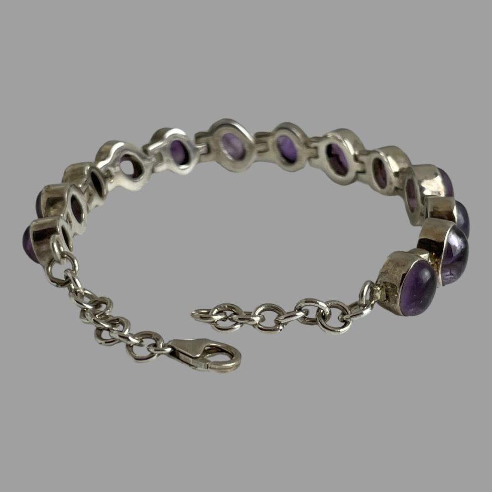 Photo showing the bracelet displayed in a circle with the clasp and extension chain area in the foreground. The clasp is shown undone.