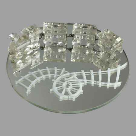 Main photo of Swarovski crystal train set displayed on the round mirror. The train and carriages are at the top of the round mirror while the white rail track which has a loop in it is seen below. The train engine is on the left with the 3 carriages attached via metal hooks and each piece is expertly crafted. A fabulous gift for the train enthusiast, Swarovski collector or 15th wedding anniversary (or anyone who loves pretty things!)