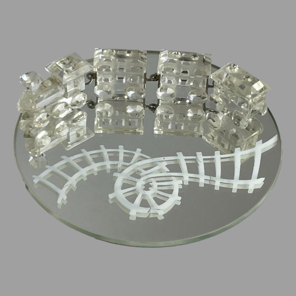 Main photo of Swarovski crystal train set displayed on the round mirror. The train and carriages are at the top of the round mirror while the white rail track which has a loop in it is seen below. The train engine is on the left with the 3 carriages attached via metal hooks and each piece is expertly crafted. A fabulous gift for the train enthusiast, Swarovski collector or 15th wedding anniversary (or anyone who loves pretty things!)