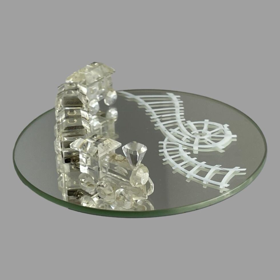 Photo of Swarovski train set this time shown from a near eye level with the train to the left and track (on the mirror) to the right of photo.