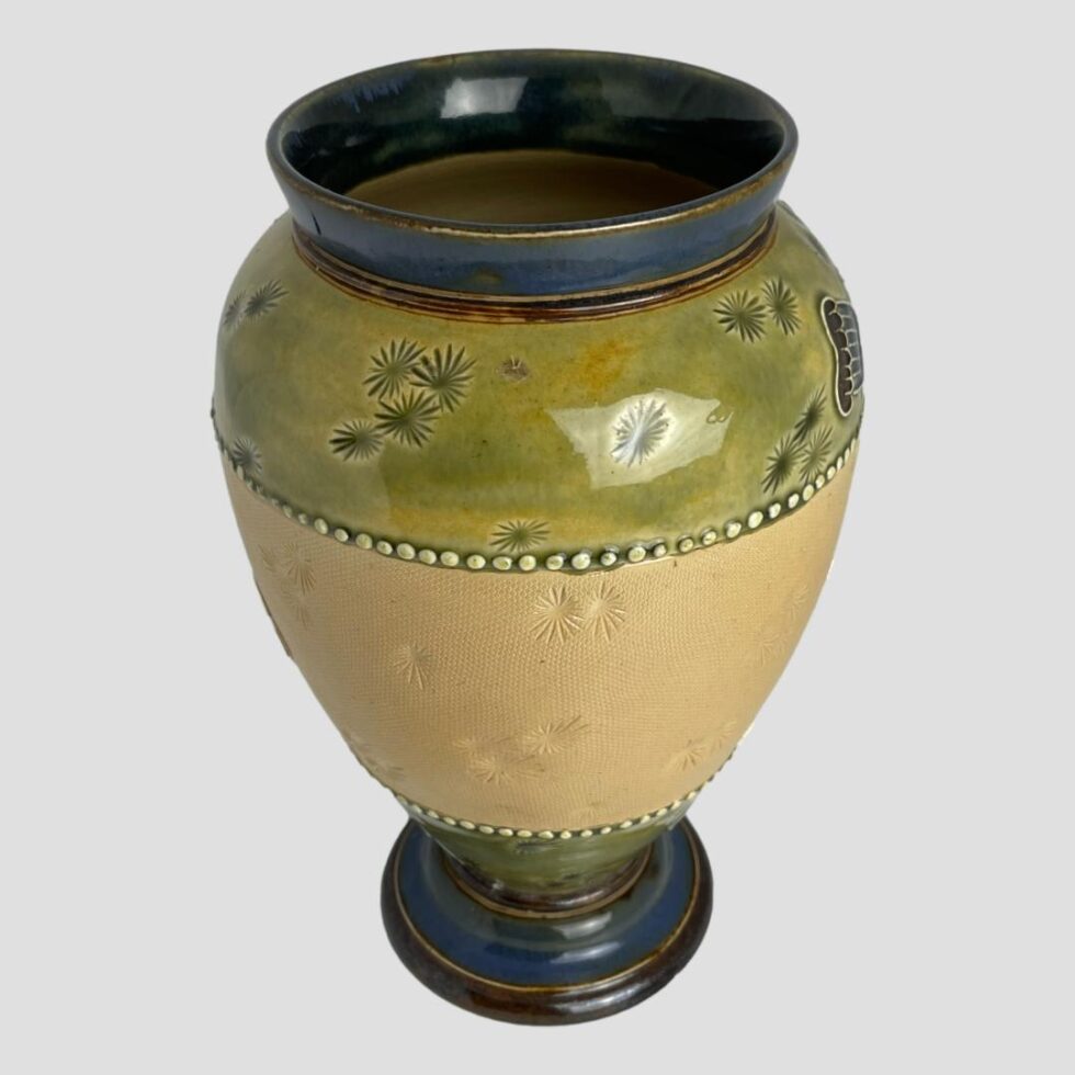 Photo of Royal Doulton poppy vase from a slightly raised angle peering slightly into the mouth. This side of the vase is completely poppy free - just the earthy dark teal blue, green and creamy yellow.