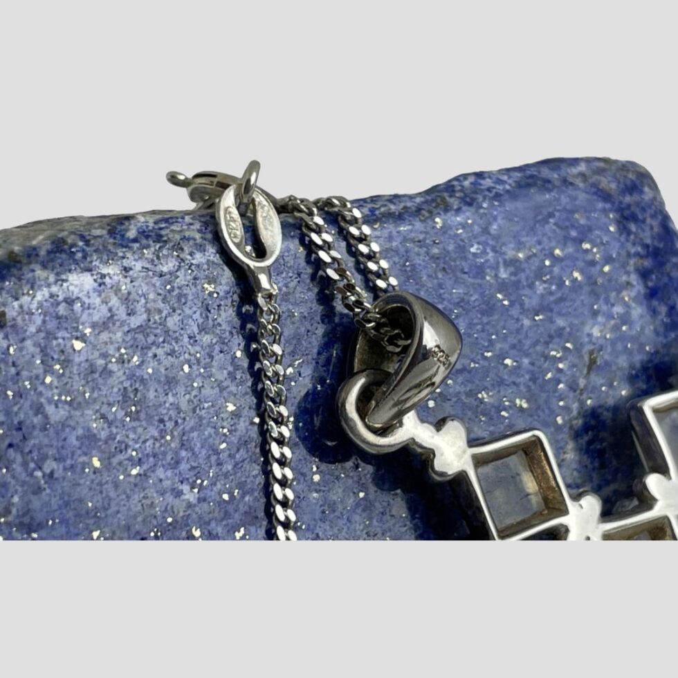 A close up of the hallmarks to the bail and clasp.