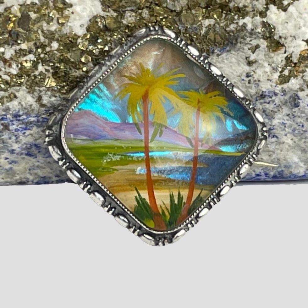 Close up photo of the image on the silver butterfly wing brooch.