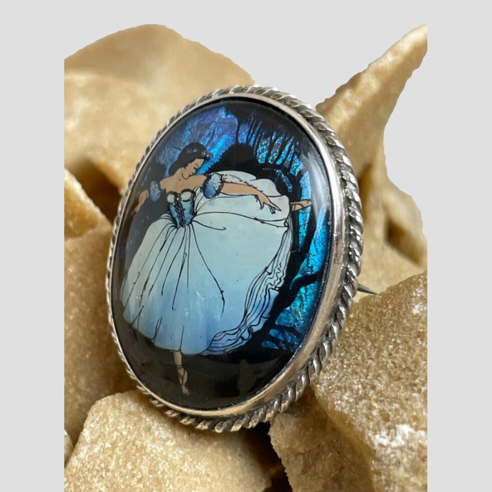 Photo of ballerina butterfly brooch displayed this time facing the bottom left corner of photo.
