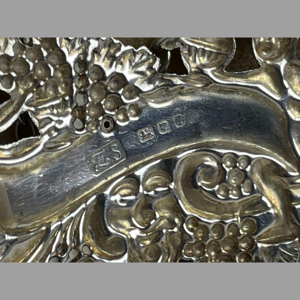 A close up photo of the full hallmark to the back of silver whisky decanter label.