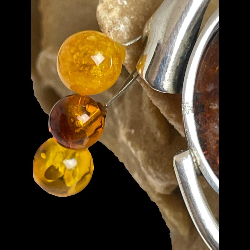 Close up photo of the 925 hallmark on the inner frame of sterling silver amber brooch.