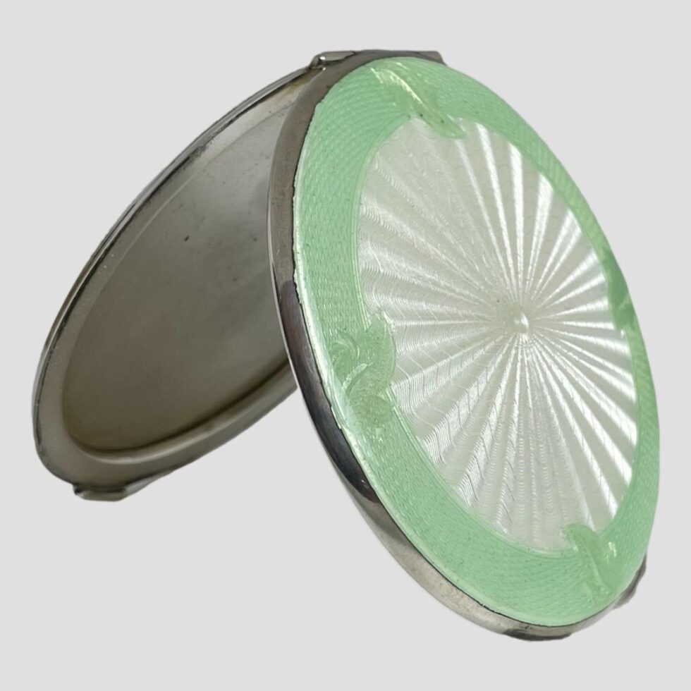 Photo of sterling silver enamel mirror displayed open and propped up by itself using the opening as the stand.