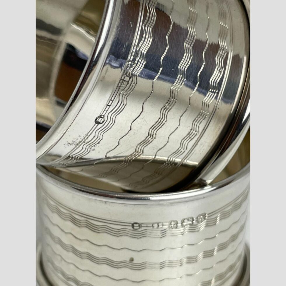 Close up photo of the hallmark on both rings which are displayed one on top of other. The hallmark for one on top is quite worn compared to lower one which is clear.