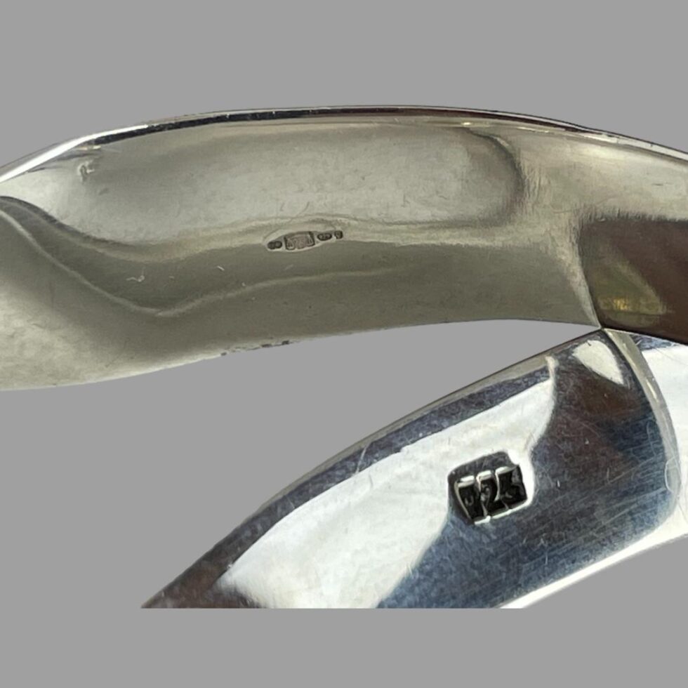 Close up photo of the 2 hallmarks; 925 on the collar and imported full hallmark on the cuff.