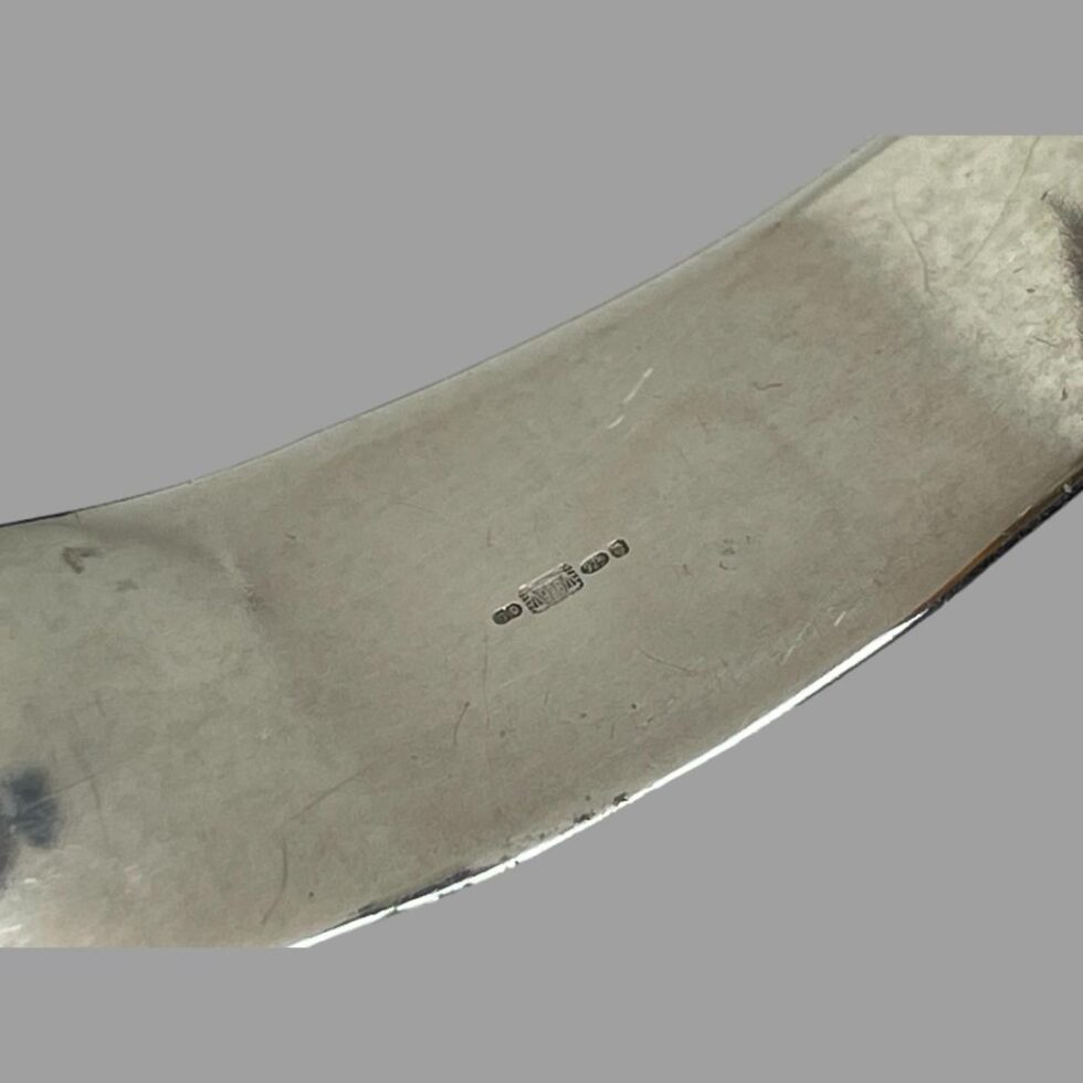 Close up photo of the full import hallmark on the cuff only.