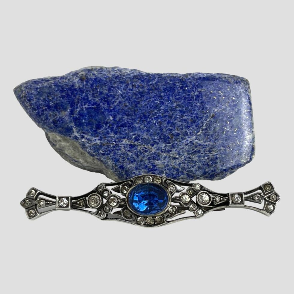 Photo of c1900 French brooch this time displayed in front of the rock of lapis with the brooch front forward facing.