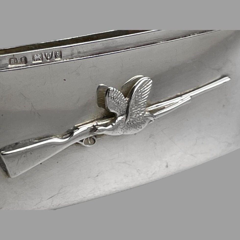 Close up photo of the bird and rifle decoration and the full hallmark on inside rim.
