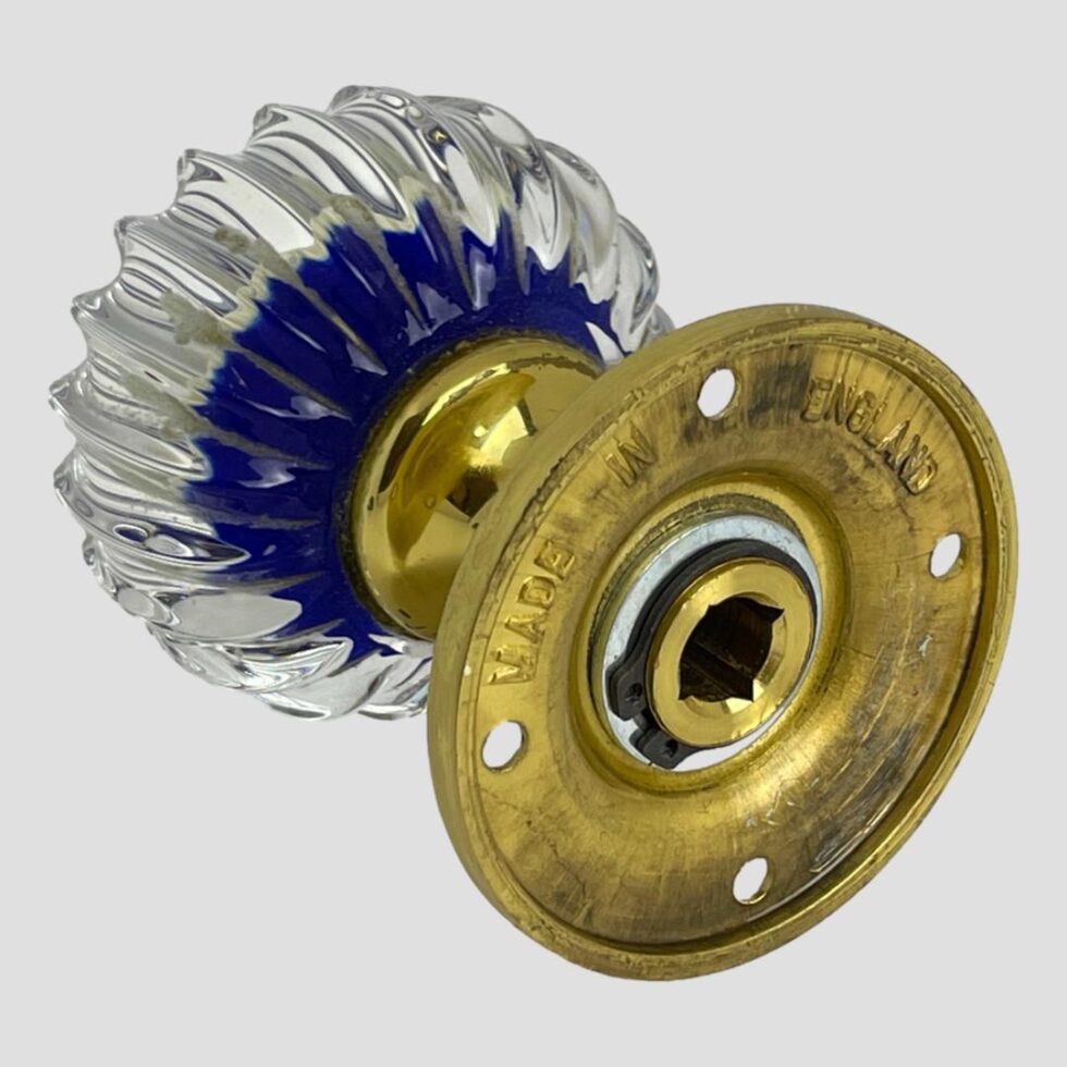 Photo of Perthshire millefiori door knob shown with the back of brass fixing in the bottom right foreground and the glass knob in top left corner.