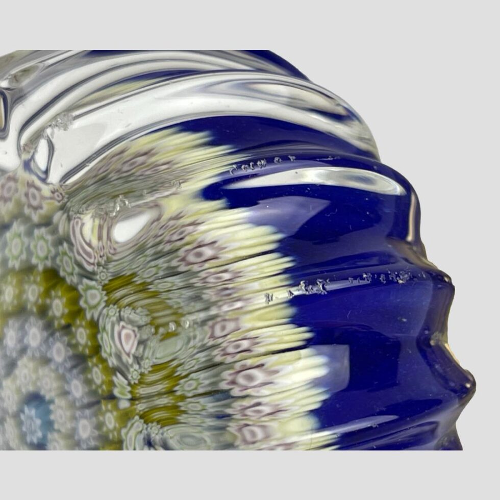 Close up photo of the small chips along 2 of the crimped edges.