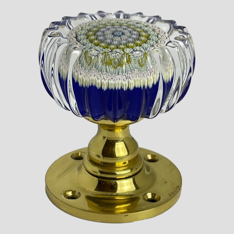 Photo of Perthshire millefiori door knob displayed stood upright on its brass door fixing with the glass knob at top.