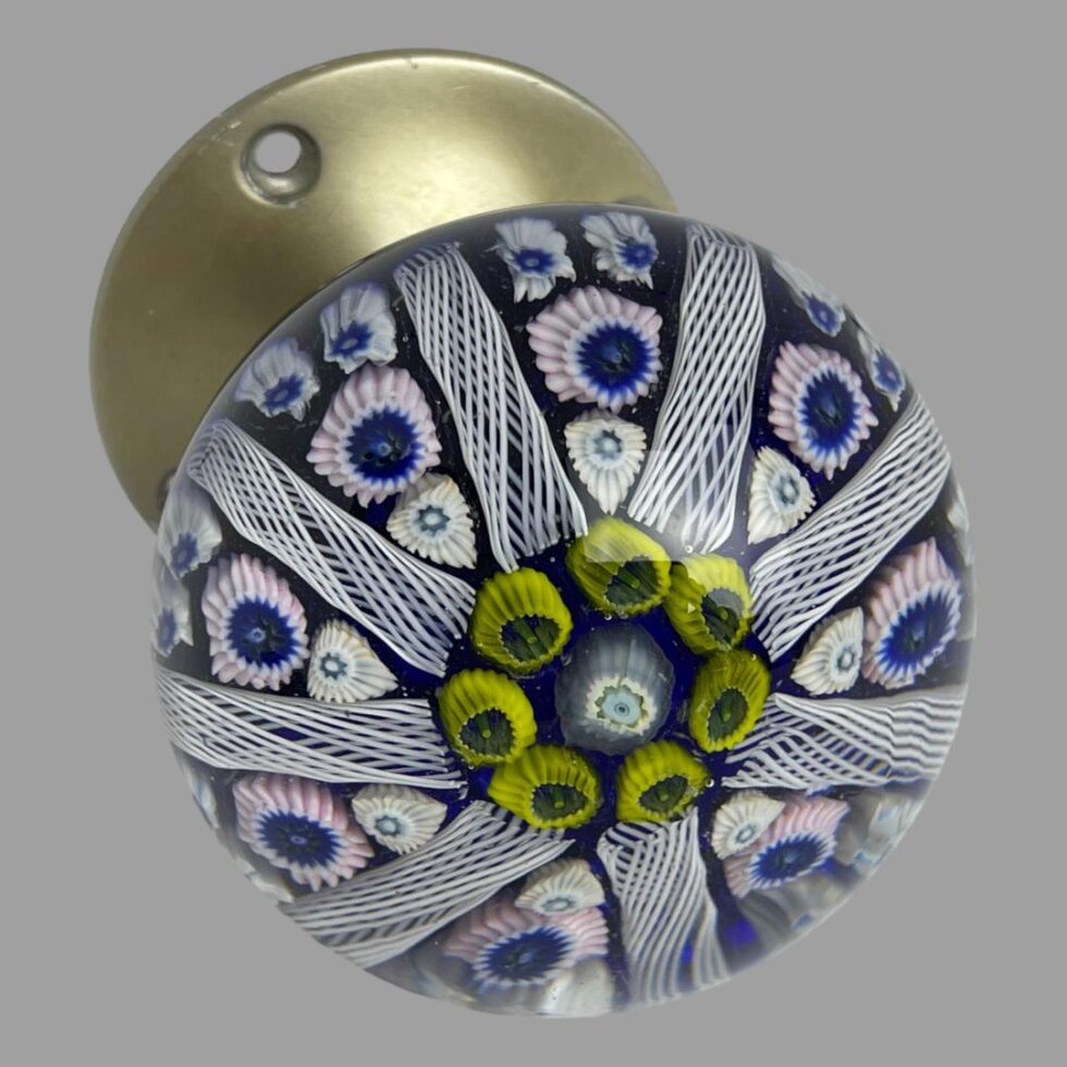 Photo of Strathearn glass door knob seen with the glass dome slightly offside to the bottom right showing part of the metal door fixing at the top left of photo.