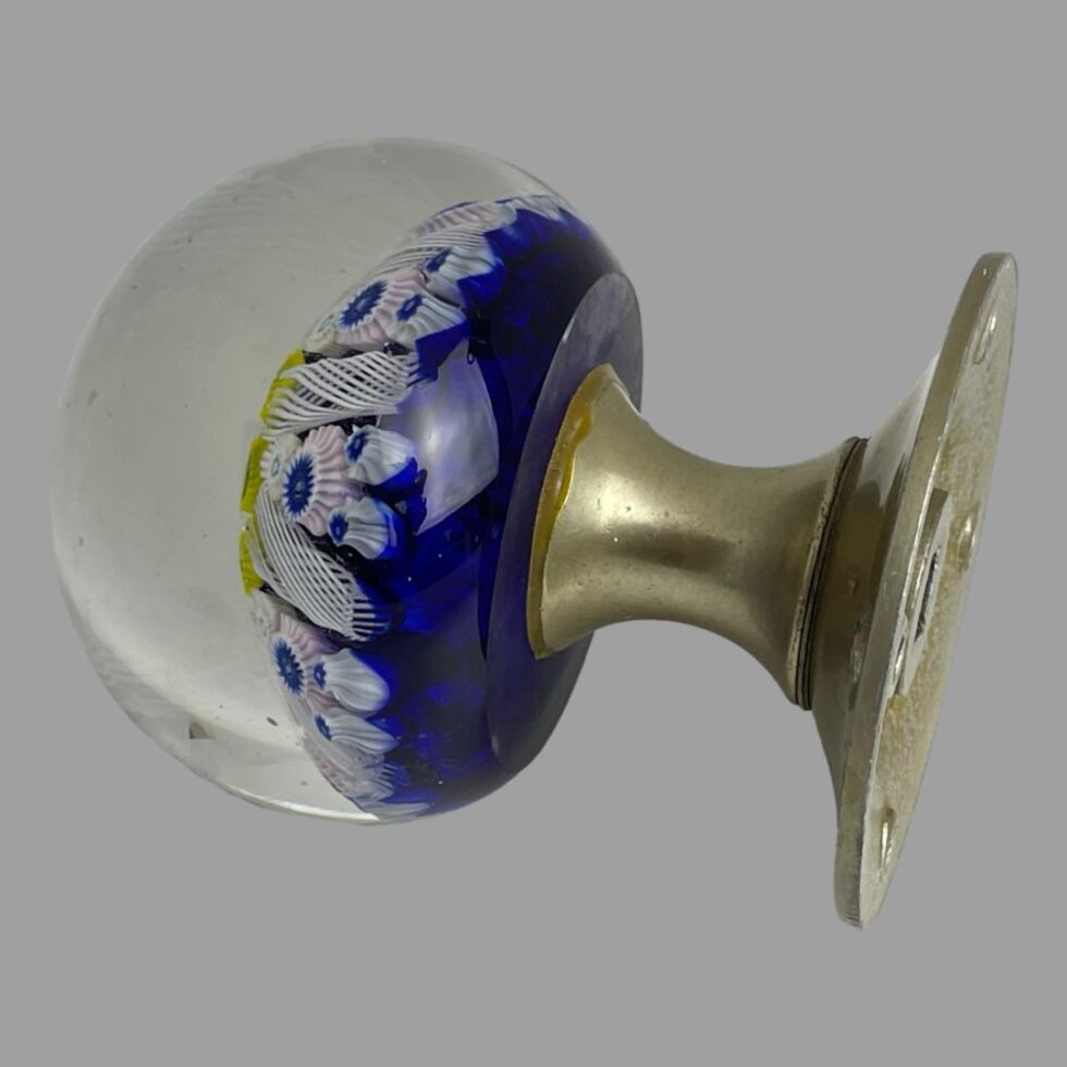 Photo of the door knob this time with the glass dome end on the left and very slightly going in to the top left corner. The purpose of this shot is to show the adhesive overflow between the glass dome and the metal fixing which is not visible from the front.