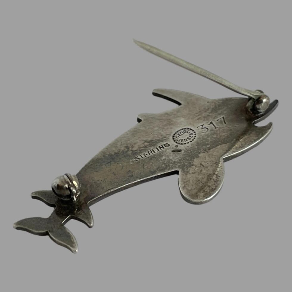 Photo of the back of the Georg Jensen dolphins brooch showing the Jensen mark and hallmark.