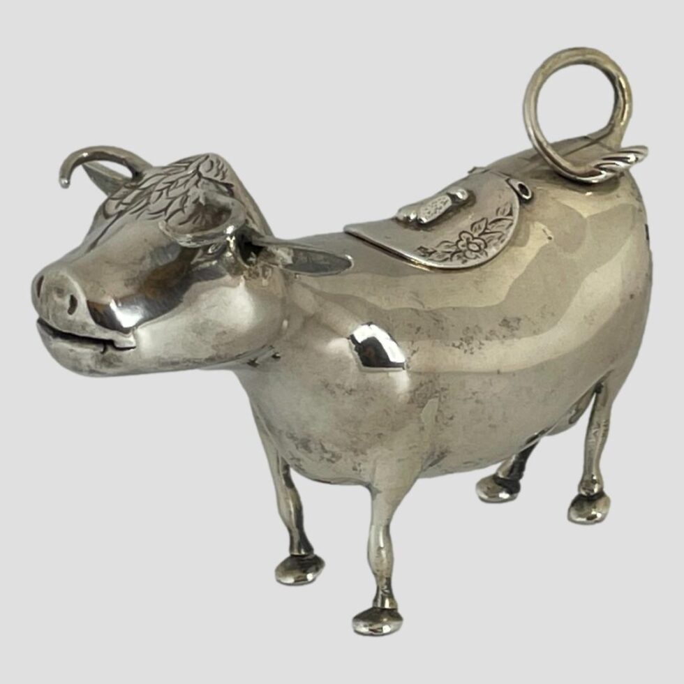 Photo of Dutch silver cow creamer again from a side view angle this time from a slightly raise4d height.
