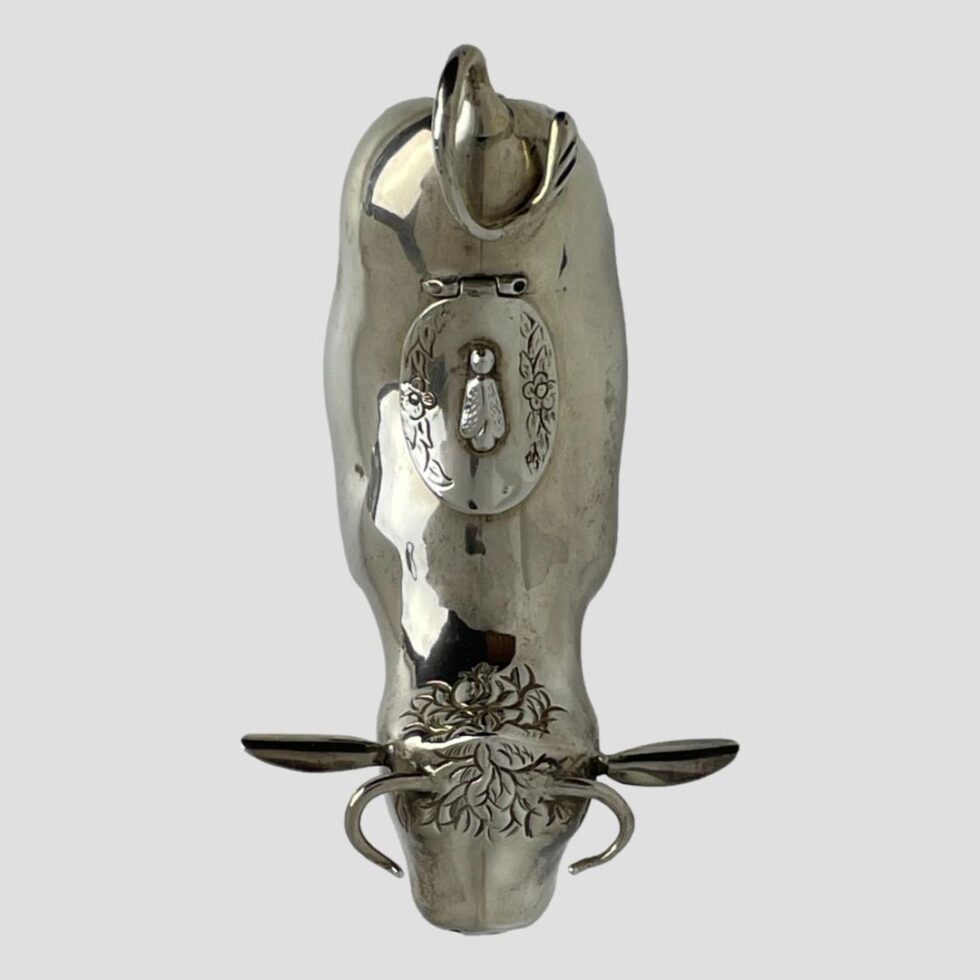 Photo of Dutch silver cow creamer looking straight down from above. The head is in the centre bottom.