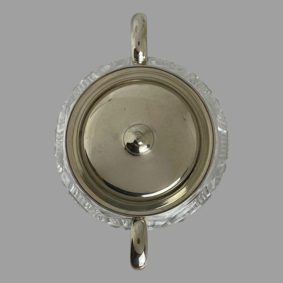 Photo looking straight down at the biscuit barrel from above. The handles are seen at centre top and centre bottom of photo and the lid is in place.