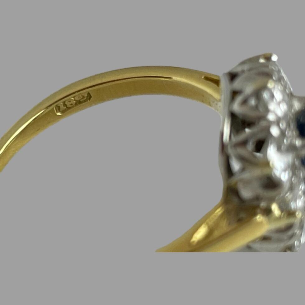 Close up photo of the 18ct gold hallmark on the inside band of ring.