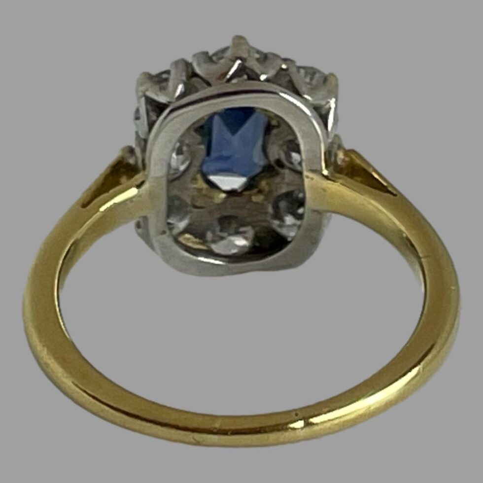 Photo of the cornflower sapphire and diamond ring seen from the back showing the setting of stones.