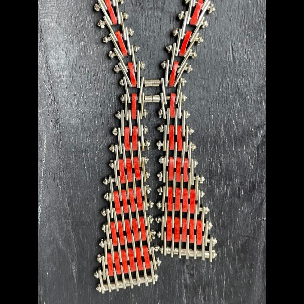 A close up of the 'ribbon' ends of the necklace with one side slightly longer than other.