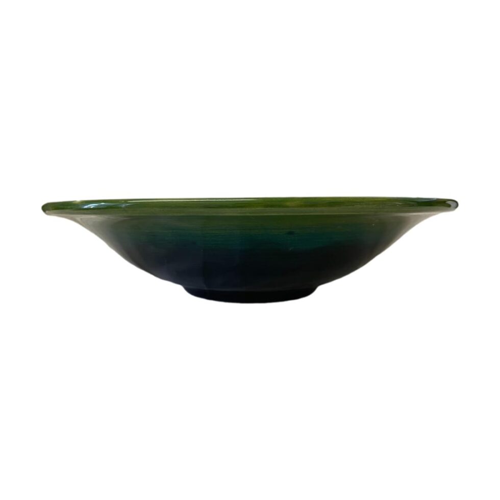 Photo of the large Moorcroft clematis bowl displayed on a flat surface and shown from an eye level to show the bowl depth.