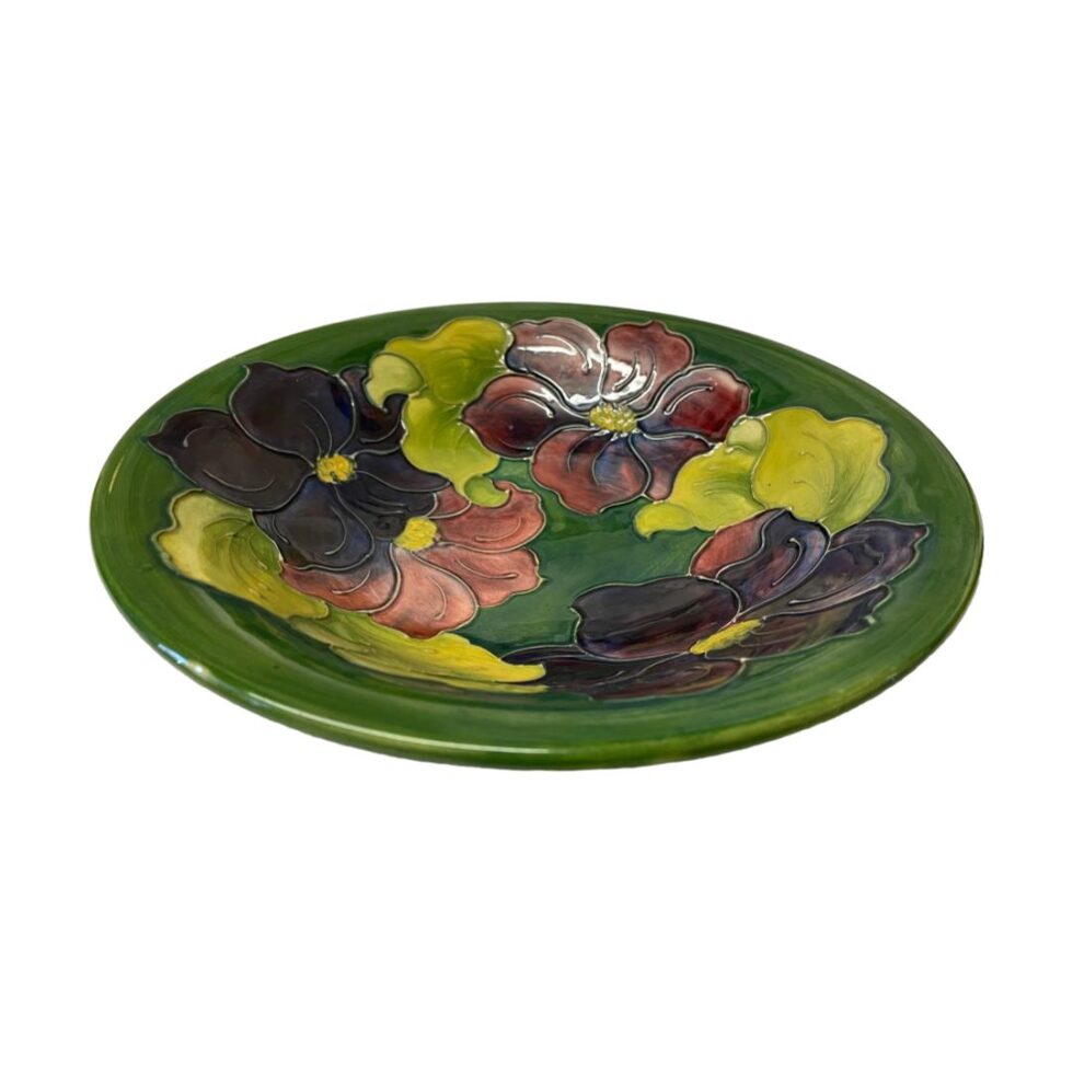 Photo of large Moorcroft clematis bowl displayed on a flat surface. We are looking diagonally down into the bowl centre from above.