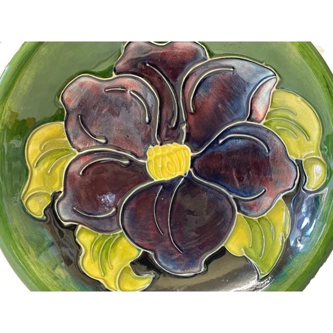 Close up photo of the large purple clematis flower at the bowl centre.