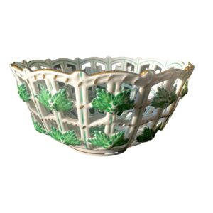 Main photo of Herend basket lattice bowl displayed on a flat surface and seen from an eye level. Around the outer lattice work, ivy leaf moulds are applied to give a 3D effect. These ivy leaves are all around the bowl on 2 levels. There is also some ivy hand-painted in the centre of the bowl. (Not visible here)