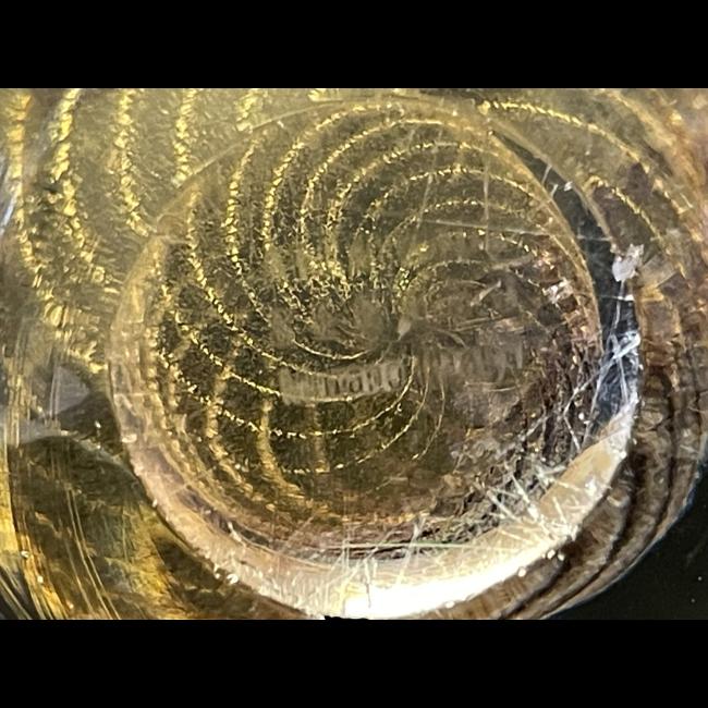 Close up photo of the Murano signature on the flat area of the base.