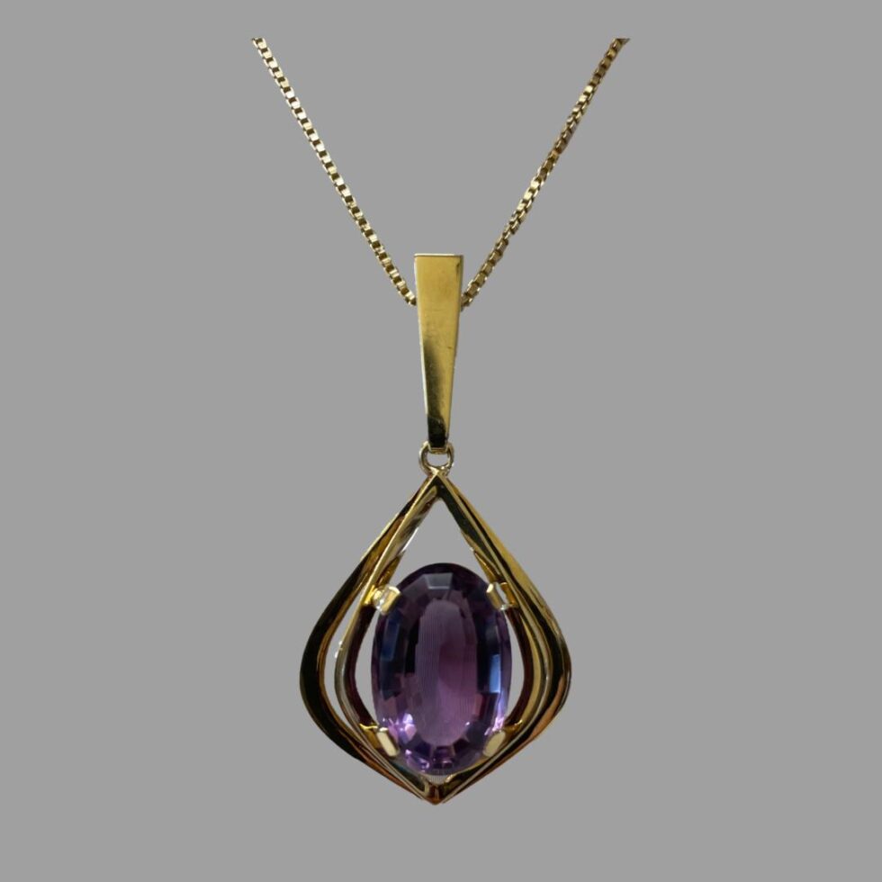 Close up photo of the front of the gold amethyst pendant.