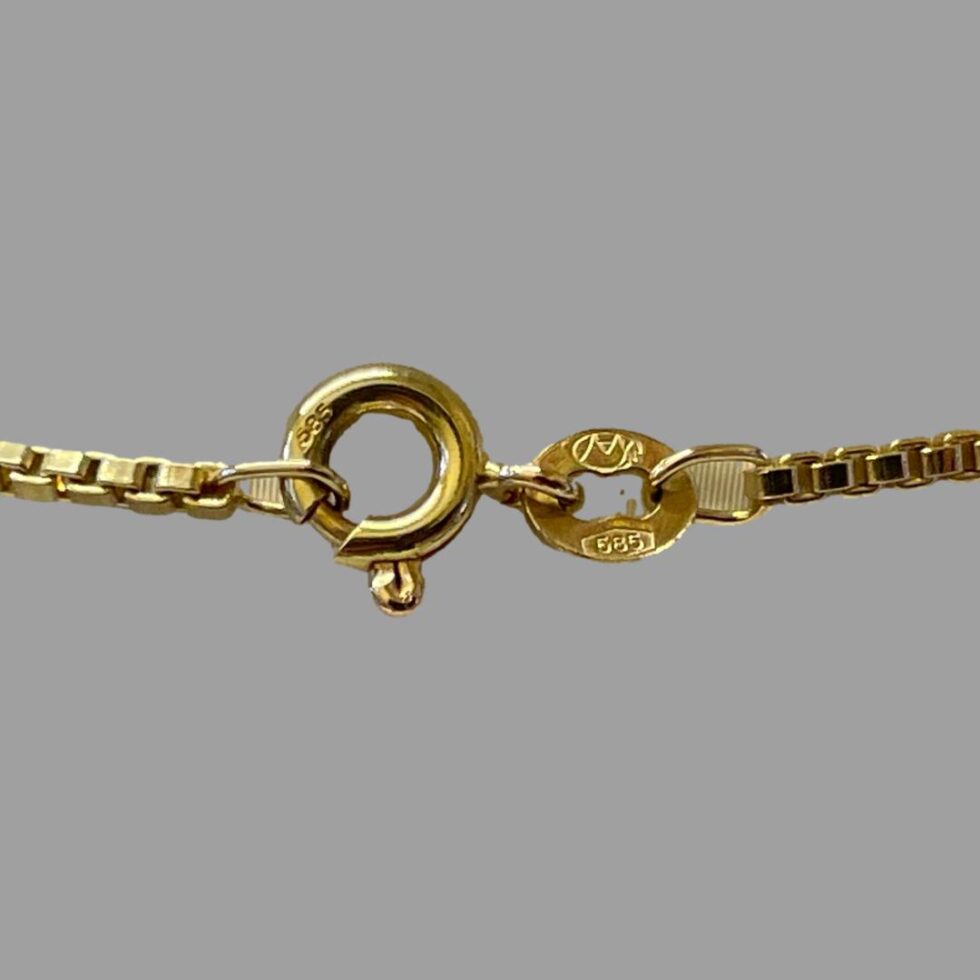 Close up photo of the hallmarks on the necklace clasp.