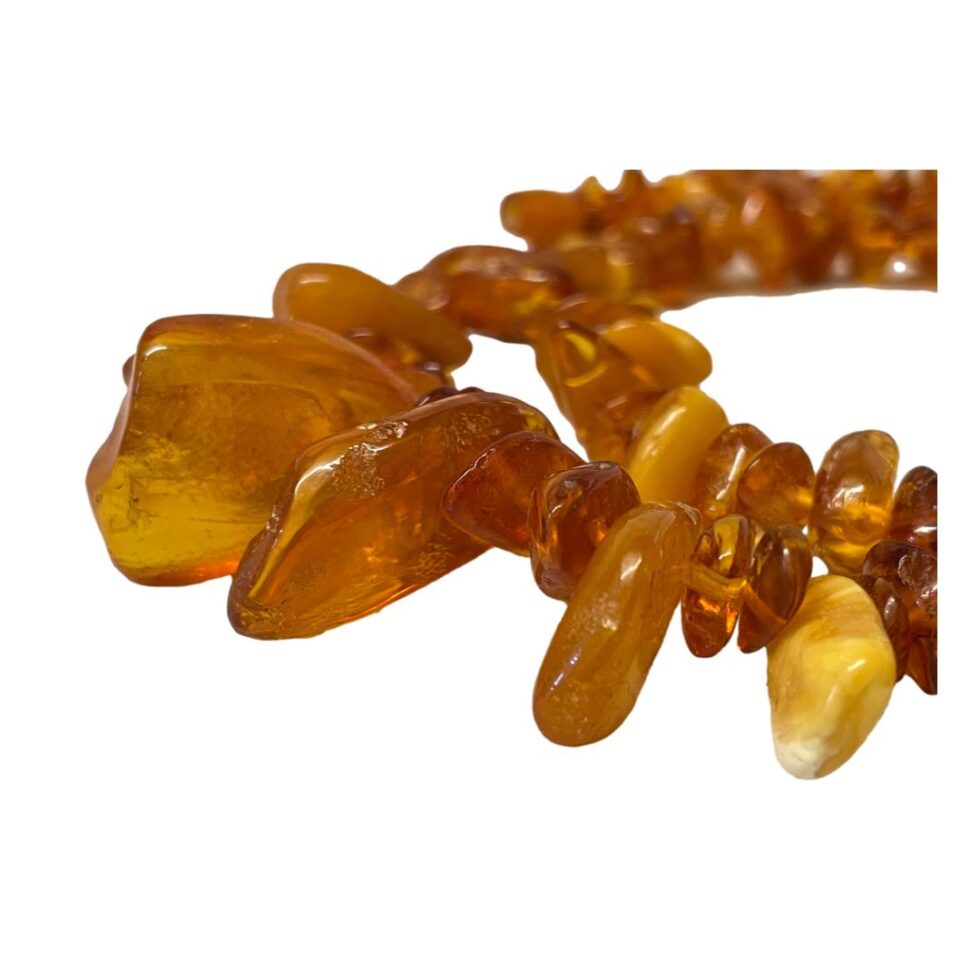 A close up of some of the amber pieces. A couple of larger and longer ones on the left and a short egg yolk one visible on the right.