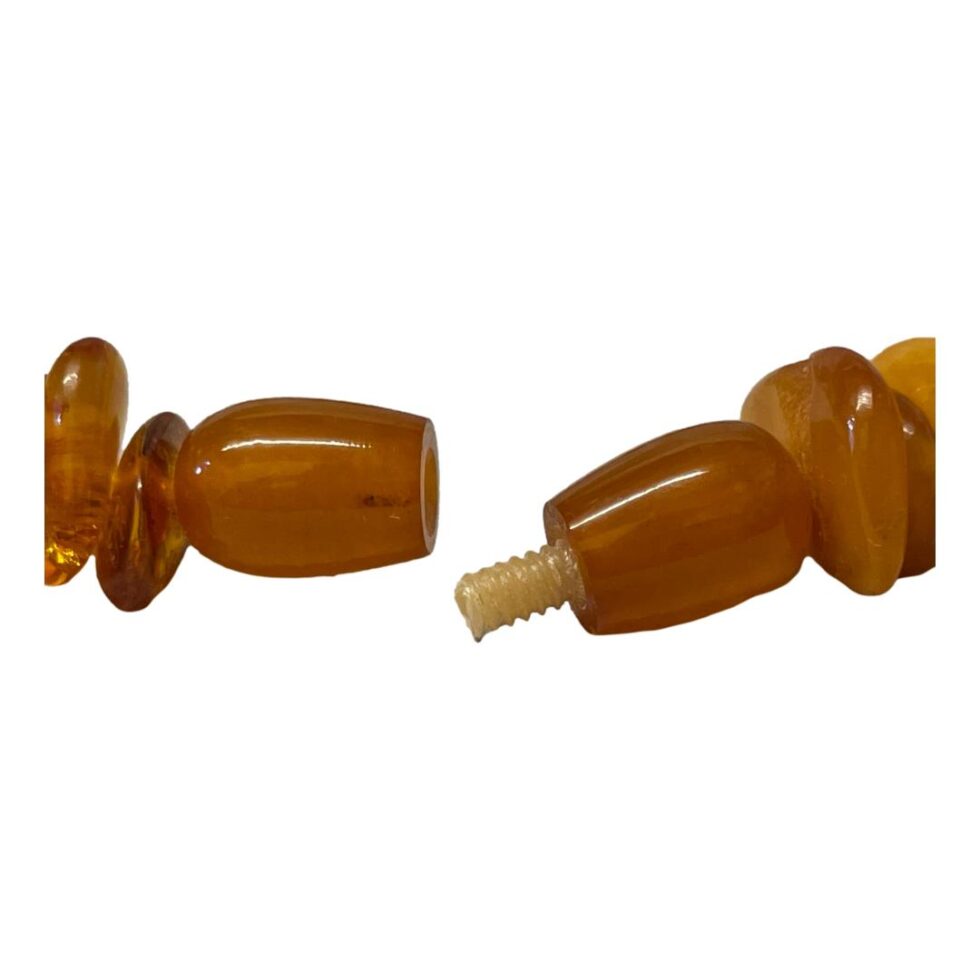 A close up of the amber screw clasp which is shown open.