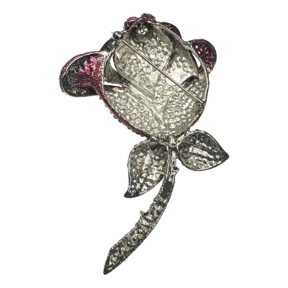 Photo of the back of the Butler & Wilson rose brooch displayed mirrored to the main photo. Just silver metal this side with tinges of red coming through from the flower head.