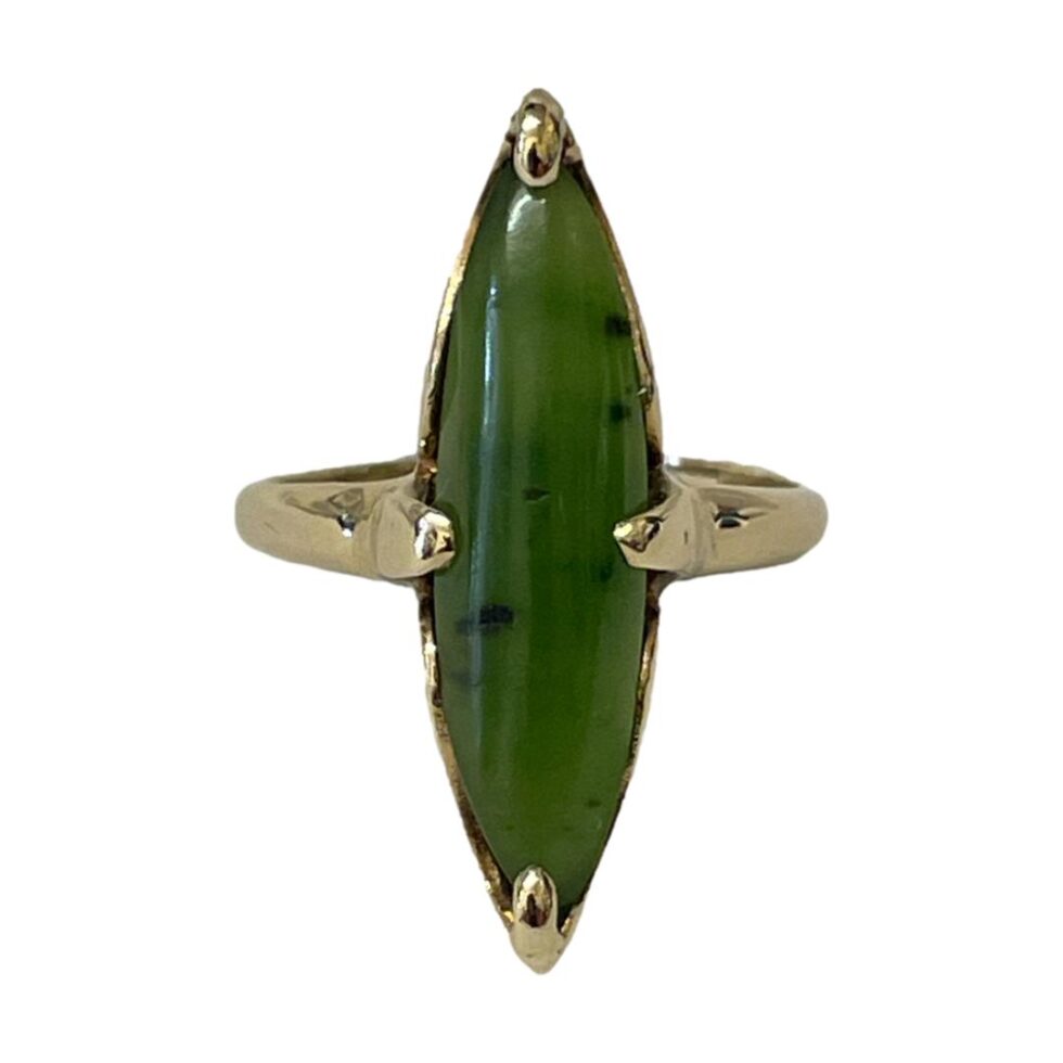 Photo of 10Kt gold jade ring displayed forward facing against a white background. The dark inclusions in the jade are visible well here.