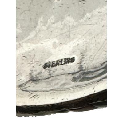 Close up photo of the sterling hallmark on the back of buckle.