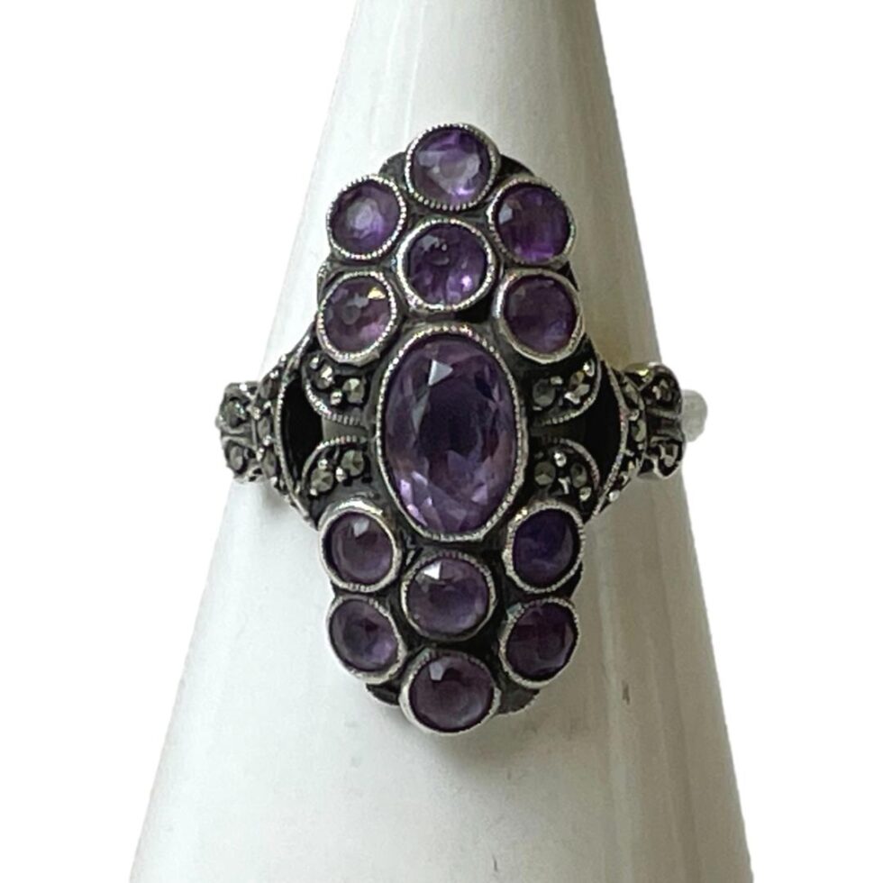Main photo of 935 silver &amethyst ring displayed on a white cone shaped stand and seen with the ring front forward facing.