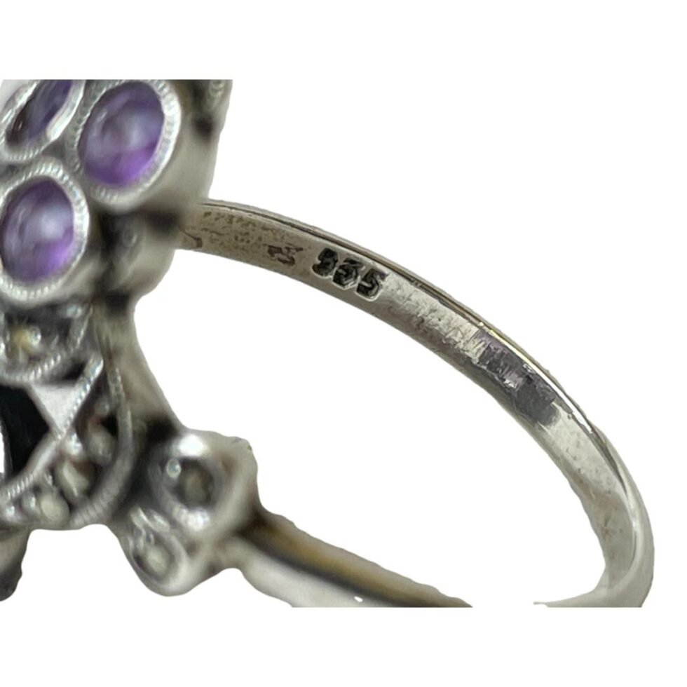 Close up photo of the 935 silver hallmark on inside band of silver amethyst ring.