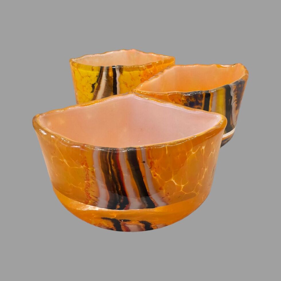 Photo of the 3 sections displayed with one curved side of each in the foreground. The pieces are displayed one in front of the other alternating left to right.