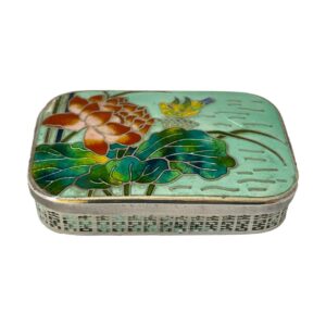 Main photo of Korean silver &enamel box displayed on a flat surface and seen from a little height looking diagonally down. Sadly not in perfect condition, this box is still stunning to behold and equally very usable. The colours of the enamel on the lid are incredibly eye catching with the red lotus flower to the top left, the yellow water fowl to top centre, lovely green blue colours of the lotus leaves which cover almost all the lower part of the image then pale green blue colour of the water to the right.