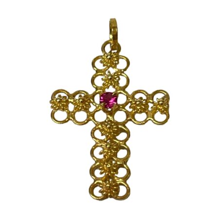 Main photo of 18Kt cross with ruby displayed against a white background with the front of cross forward facing. The gold work of the cross is as explained in description and the ruby which is round cut is a wonderful shade of almost shocking pink.