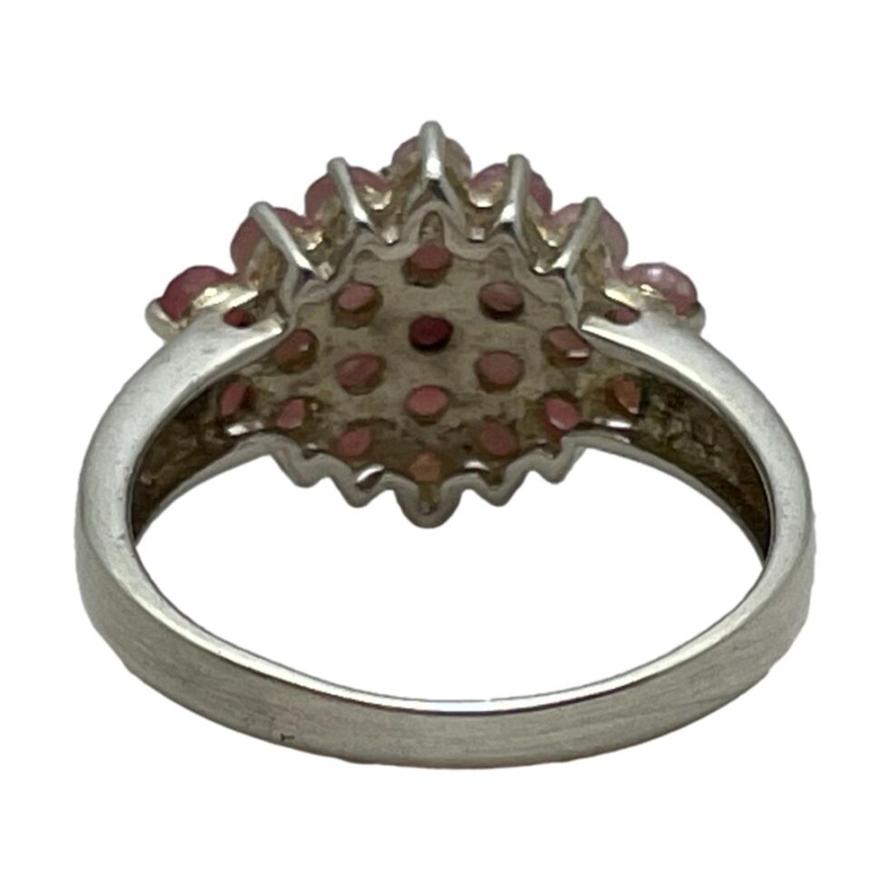Photo of the back of the silver ruby cluster ring showing the solid setting for the stones.